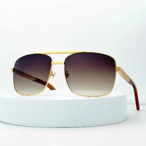 Gold-framed sunglasses with gradient lenses on a white background