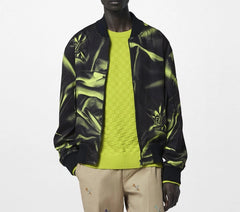 Person wearing a black and yellow jacket over a green sweater on a white background