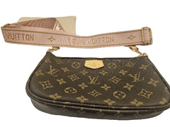 Louis Vuitton handbag with monogram pattern and pink strap on a white background