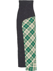 A high-waisted asymmetrical knit skirt with a dark charcoal gray side and a green and cream plaid side panel, shown against a plain white background.