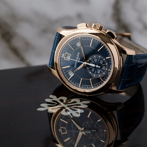 Luxury watch with detailed face and rose gold case on a dark surface