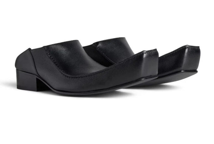Black sandal with a unique design on a white background