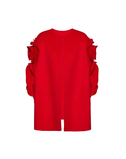 A bright red cropped sweater with dramatic ruffled shoulder details, shown against a plain light gray background.