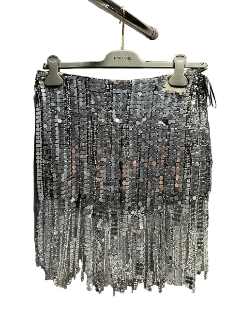 A silver tinsel fringe chandelier hanging from a black metal rod against a dark background.