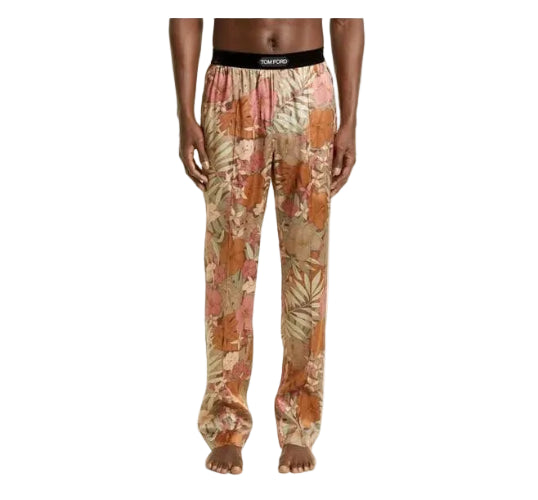 A model is shown from the waist down wearing floral pajama pants with a tropical leaf pattern in shades of orange, pink, and beige, featuring a black elastic waistband with the brand name 'SOURLEMOND' visible.