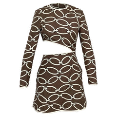 A long-sleeve mini dress with a brown and off-white chain-link pattern, featuring a crossover front and a curved side cutout, shown against a plain white background.