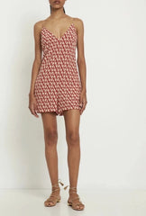 Woman wearing a red patterned dress on a white background