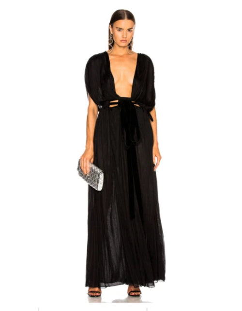 Woman wearing a black evening gown with cut-out design on a white background