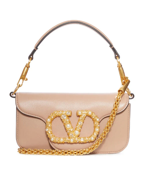 Beige handbag with gold chain and embellished 'VD' logo on a white background