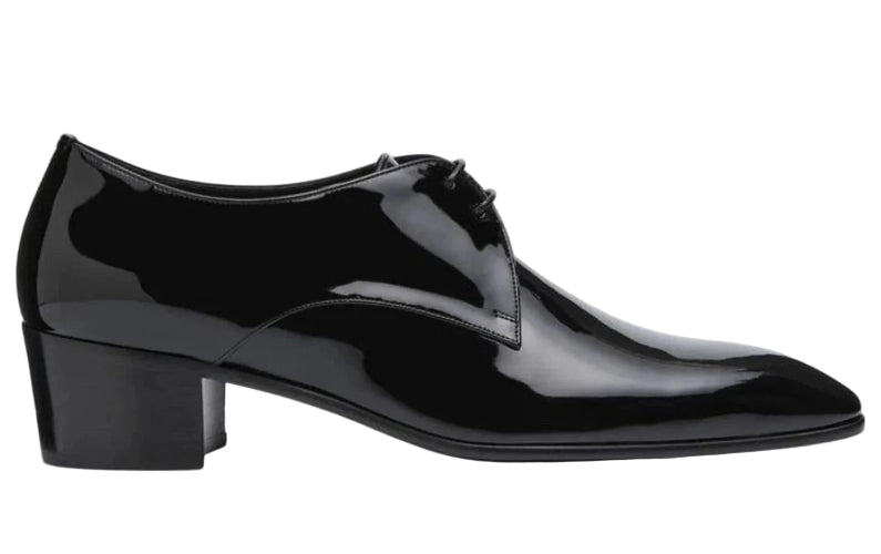 A black patent leather oxford shoe with a low block heel, shown from a side profile view against a white background.