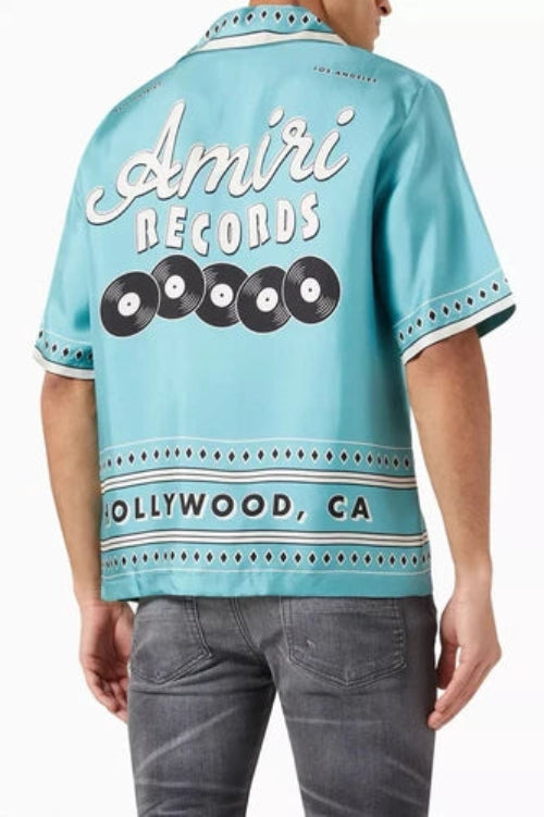 Light blue shirt with 'Amiri Records' branding worn by a person