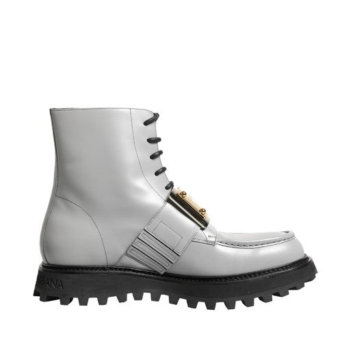 A white lace-up ankle boot with a chunky black lug sole and a gold-tone decorative buckle detail on the side, shown against a plain white background.