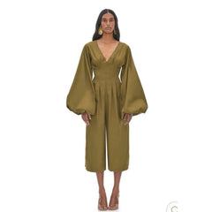 Woman wearing a green jumpsuit on a white background