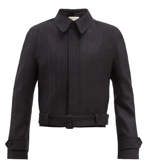 A black cropped jacket with a pointed collar and long sleeves, shown against a plain white background.