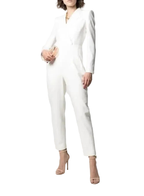 Person wearing a white jumpsuit on a plain background