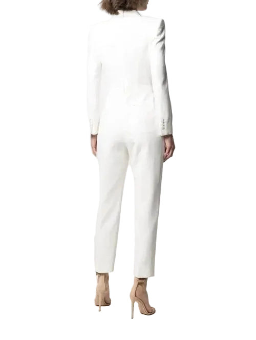 Person wearing a white long-sleeve dress against a white background