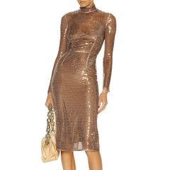 Bronze metallic dress worn by a model with a gold clutch.