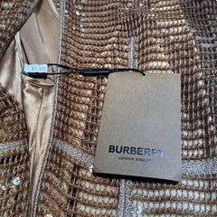 Burberry coat with a tag on a textured background