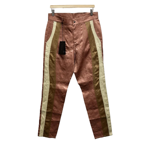 Brown pants with gold stripes hanging against a white background