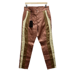 Brown pants with gold stripes hanging against a white background