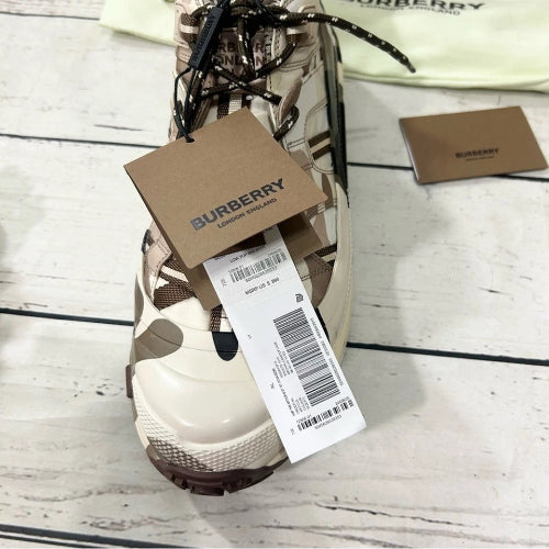 Burberry sneaker with a tag on a wooden surface