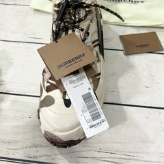 Burberry sneaker with a tag on a wooden surface