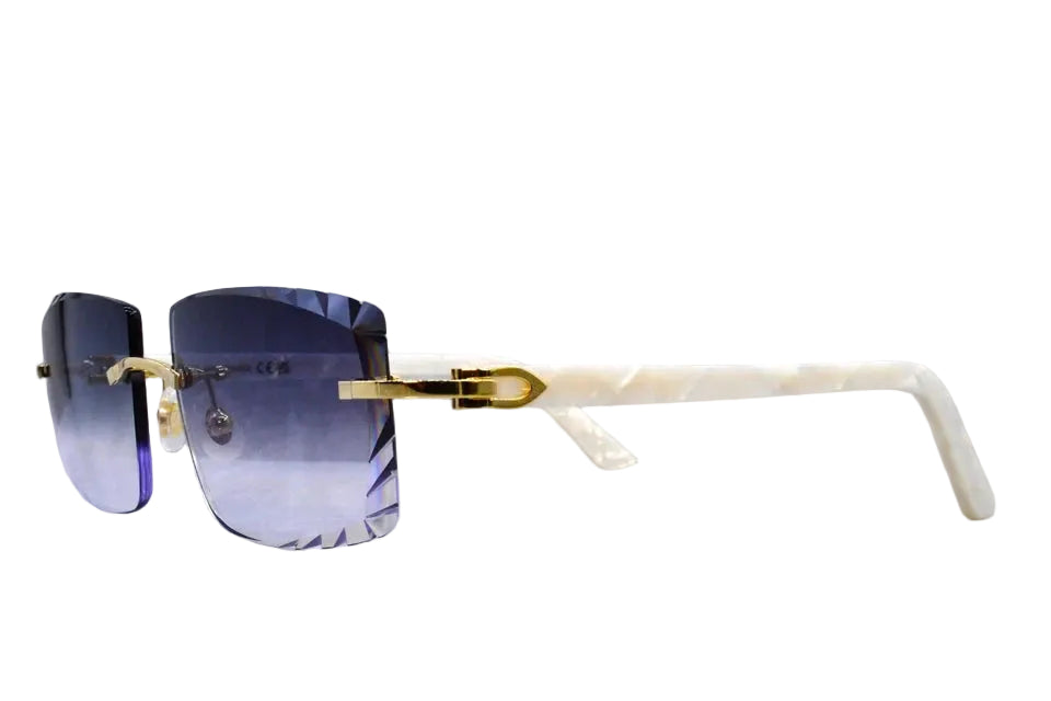Sunglasses with gold frame and blue gradient lenses on a reflective surface.