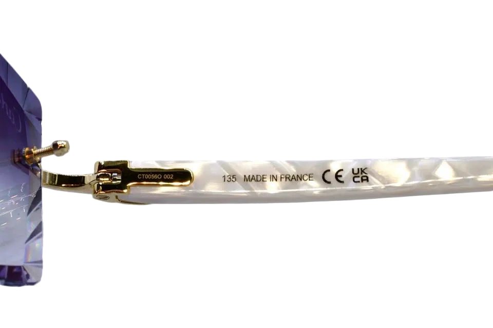 Eyeglass frame with gold accents on a white background