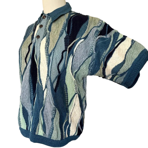 Short-sleeve knit shirt with abstract pattern on a mannequin against a white background