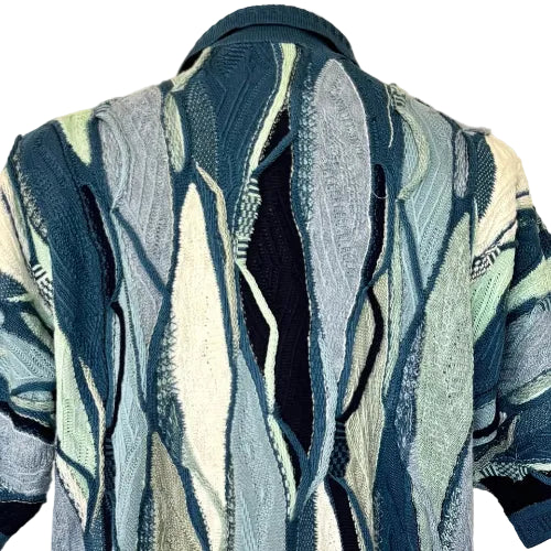 Patterned sweater with abstract design on a mannequin against a plain background