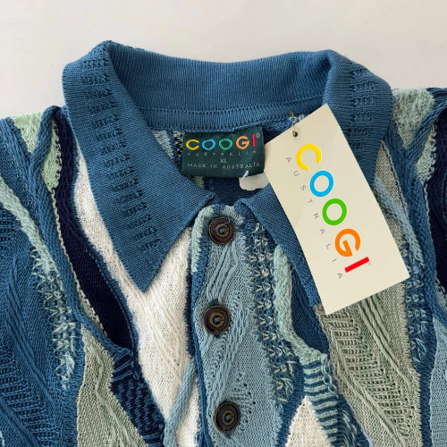 Blue knitted cardigan with a visible brand tag on a neutral background
