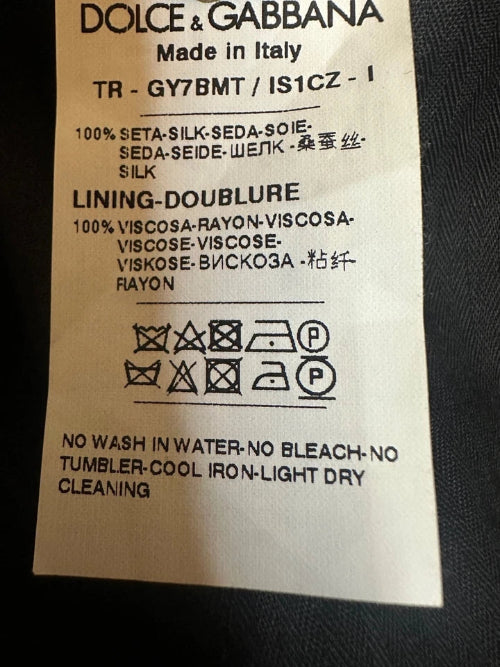 Dolce & Gabbana label with text and symbols on a dark background