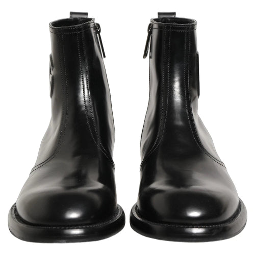 A pair of black leather ankle boots with elastic side panels and side zippers, shown against a plain white background.