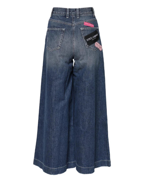 Blue wide-leg jeans with brand label on a white background