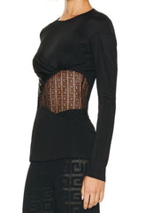 Black long-sleeve top with geometric patterned panel on a white background