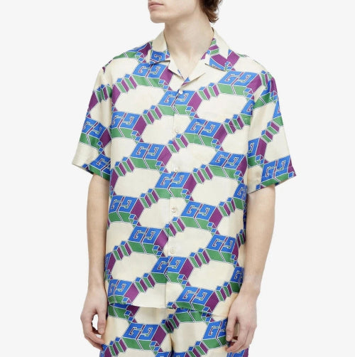 Person wearing a patterned shirt with geometric design on a white background