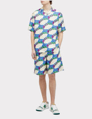 Person wearing a colorful geometric patterned dress on a white background