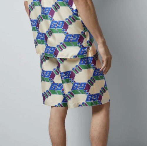 Person wearing a patterned outfit with geometric design on a plain background
