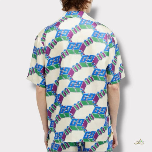 Person wearing a shirt with a geometric pattern on a white background