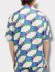 Person wearing a shirt with a geometric pattern on a white background