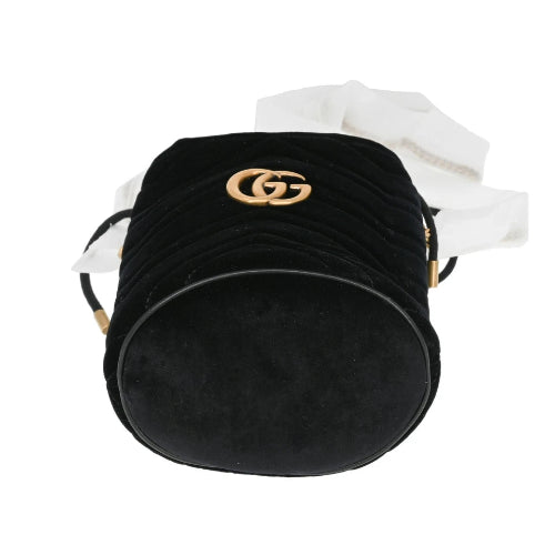 Black velvet handbag with gold logo on a white background