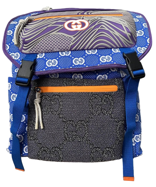 Designer backpack with blue and gray pattern on a neutral background