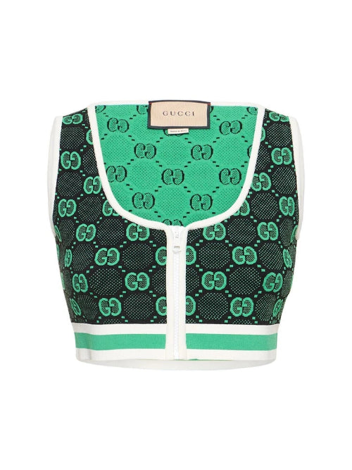 Green and black patterned Gucci bag on a white background