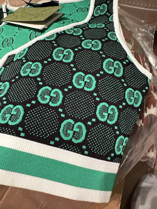 Green and black patterned garment with visible branding on a table.