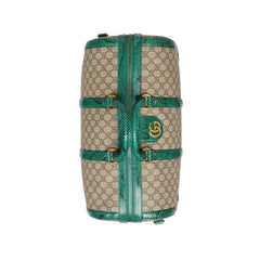 Designer handbag with green accents on a white background