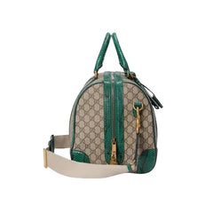 Designer handbag with green and beige pattern on a white background
