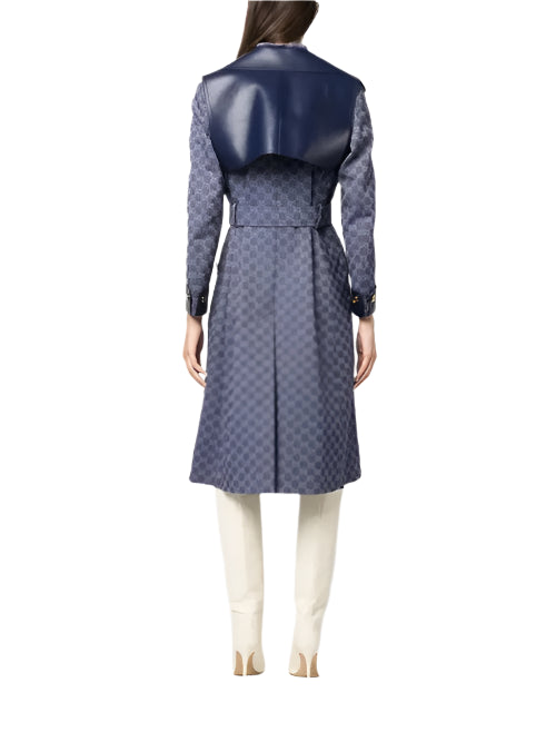 Person wearing a long blue patterned coat on a white background