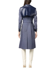 Person wearing a long blue patterned coat on a white background