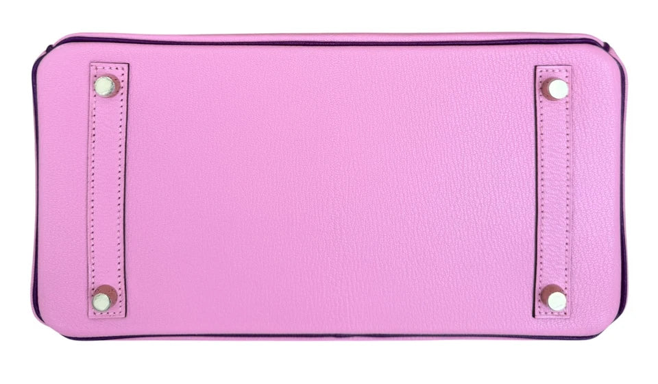 Pink wallet with decorative studs on a white background