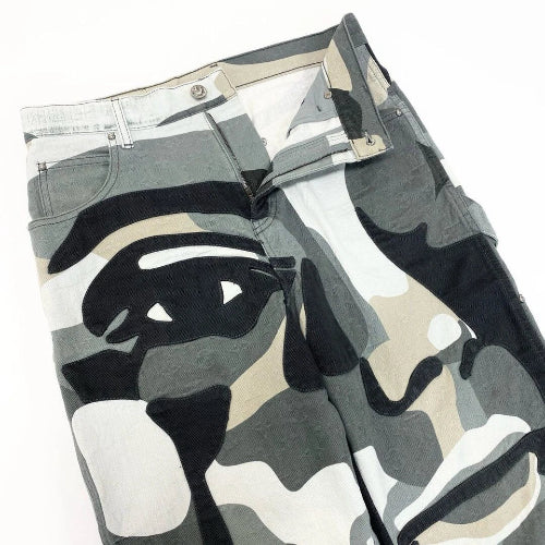 Camouflage-patterned wallet with a face design on a white background